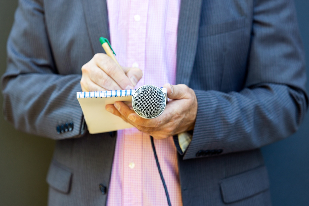 Public relation (PR) officer working at press conference or media event